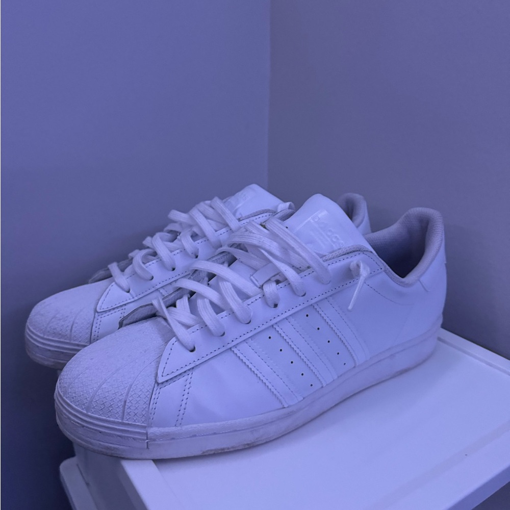 All white Adidas Superstars